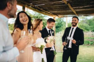 Bride, groom, and several guests at outdoor wedding
