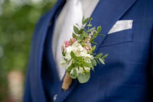 Boutonnière pinned on groom's suit