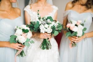 Bride and bridesmaids holding modest bouquets