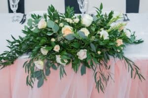Wedding flowers with greenery on sweetheart table