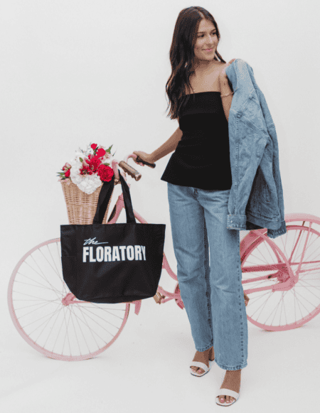 Woman standing with Floratory bike and bag
